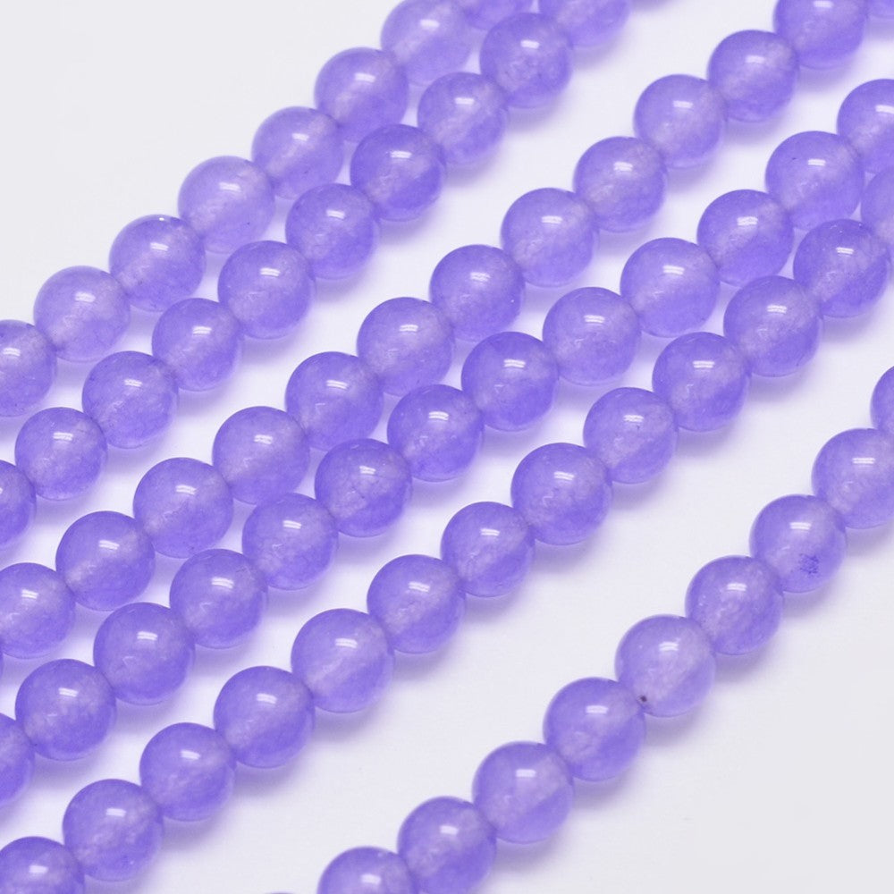 Jade lilla. Runde 6 mm. Hel streng på ca. 38 cm.