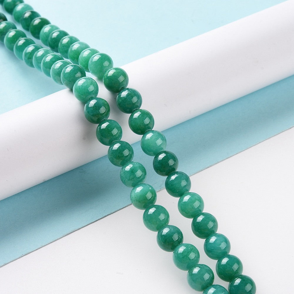 Jadeperler cyan. Runde 8 mm. Hel streng på ca. 38 cm.