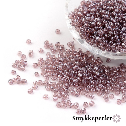 Seed beads rosebrown transparent. Ca. 3 mm.