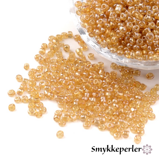 Seed beads gylden transparent. Ca. 3 mm.