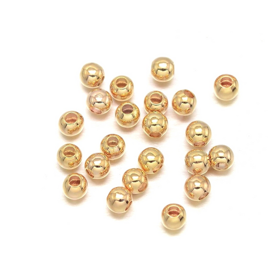 Mellemperler kugler 2mm. 18k guld.  ca. 50 stk.