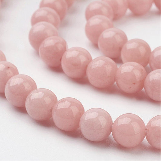 Jadeperler fersken-blush. Runde 6 mm. Hel streng på ca. 38 cm.