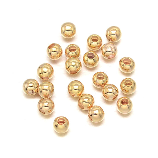 Mellemperler kugler 3mm. 18k guld.  ca. 30 stk.